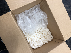 Shipping box containing peanuts and plastic