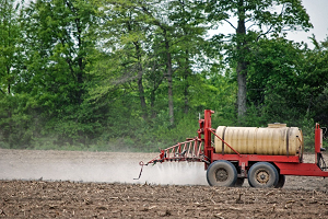 truck on farm spraying crops with pesticides