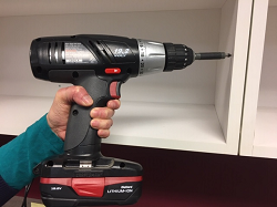 Person using an electric power drill