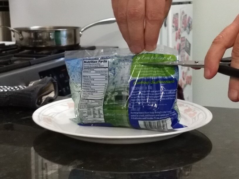 green bean pouch on plate with scissors