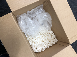Protective Packaging Shipping box containing peanuts and plastic